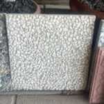 Tamamen beyaz çakılların yüzeyini kapladığı, 40x40 cm ölçülerindeki wash beton karo örneği.