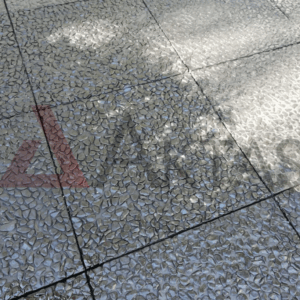 Siyah veya koyu gri çakılların baskın olduğu, güneş ışığı yansımasıyla parlak görünen wash beton karoların zemin uygulaması.